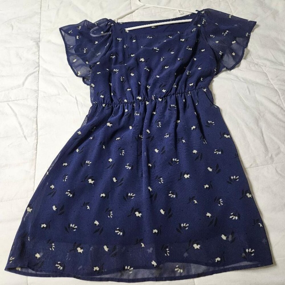 Sheer blue dress with black and white flowers.